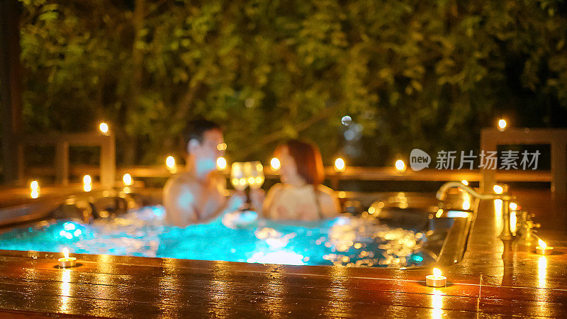 Wine glasses and couple is at hot tub bath.